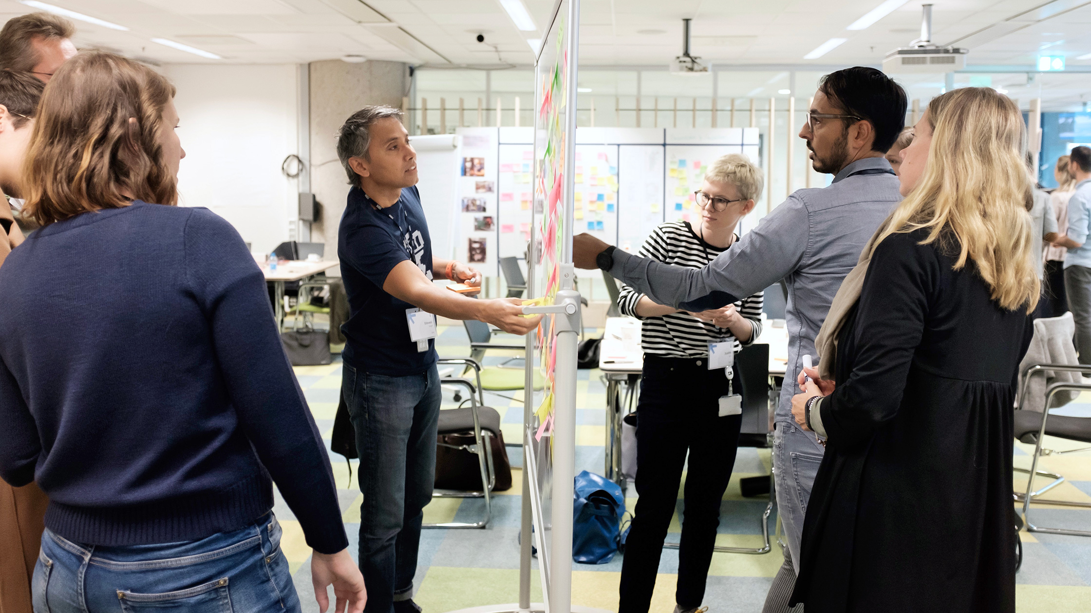 Employees work with design thinking on a board