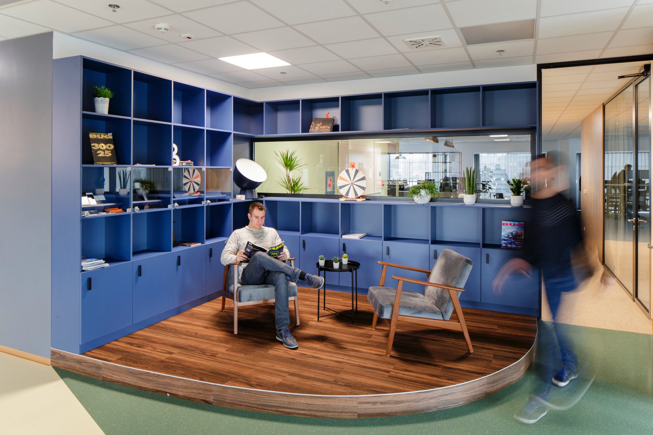 Office scene with a huge blue shelf