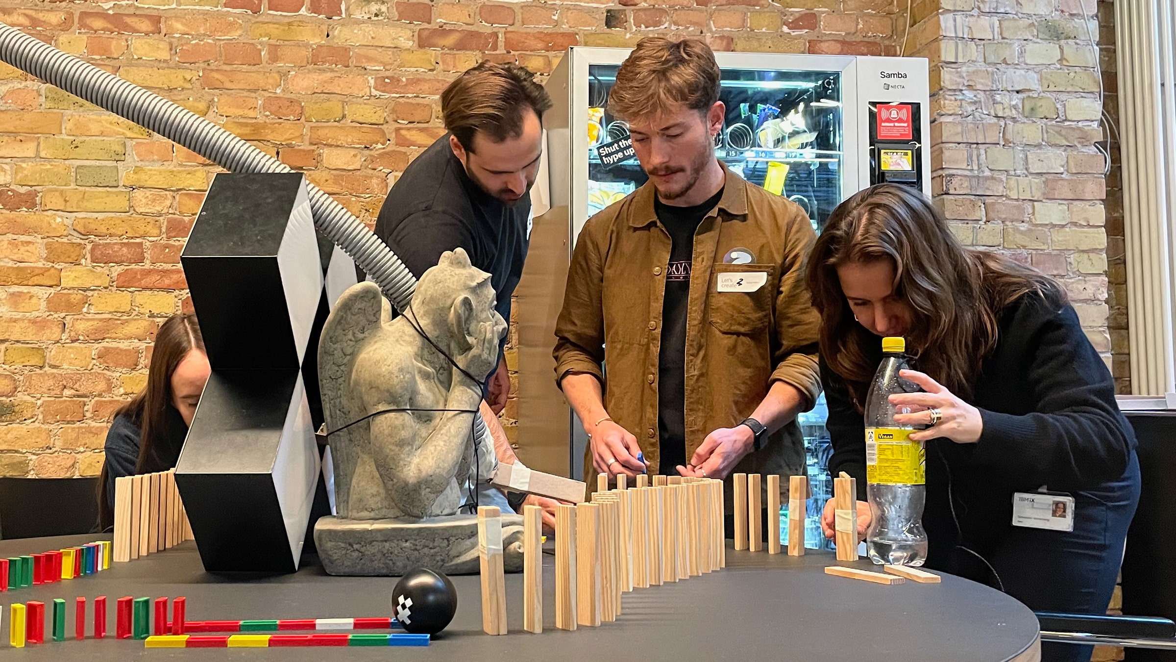 Three people are working on a design project