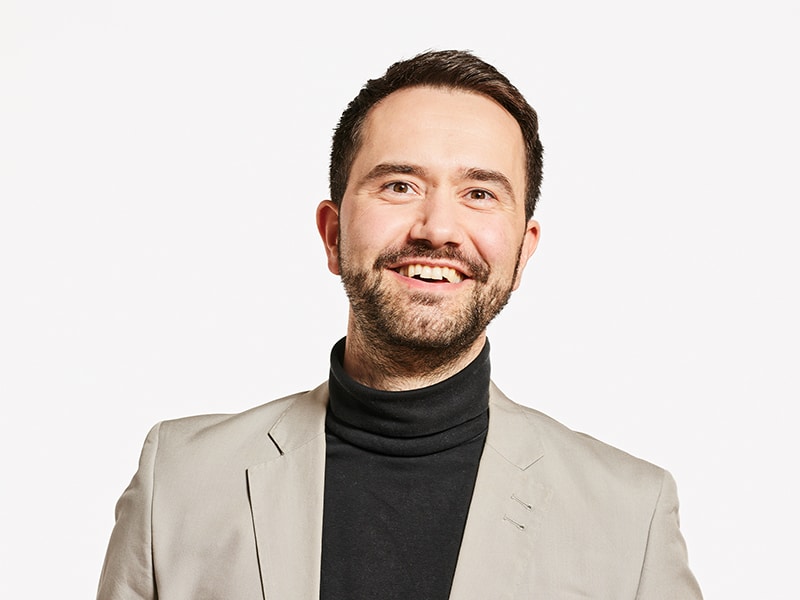 Man with beard, wearing black turtleneck