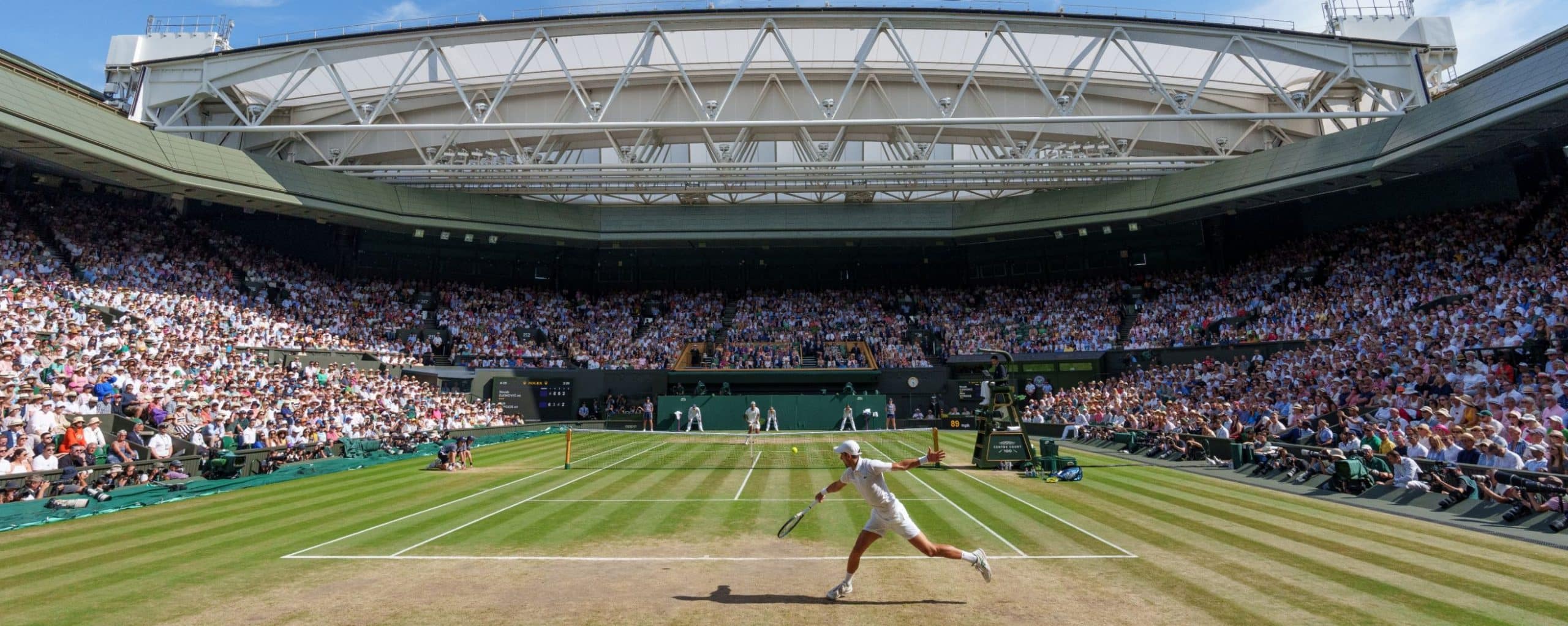 view of Wimbledon arena with tennis player