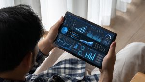 Close-up of a tablet displaying analytics dashboards and graphs, representing data driven marketing insights.